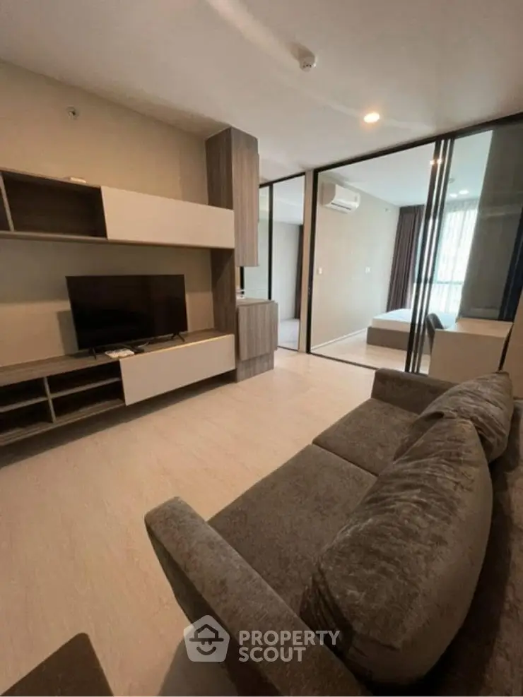 Modern living room with cozy seating and large TV setup