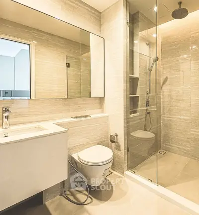 Luxurious modern bathroom with sleek design and glass shower enclosure.