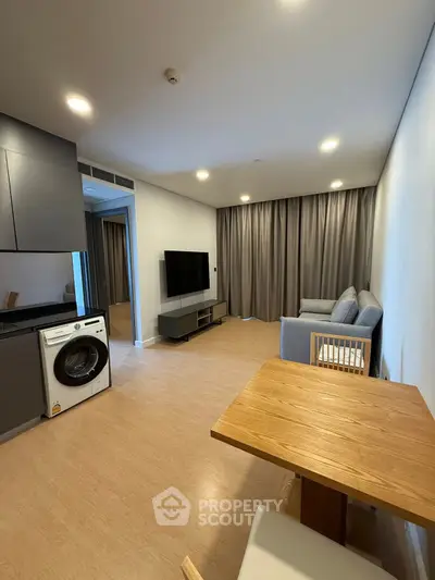 Modern living room with washing machine and sleek furniture
