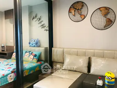 Charming bedroom with playful decor and cozy seating area, perfect for a child's room in a modern apartment.