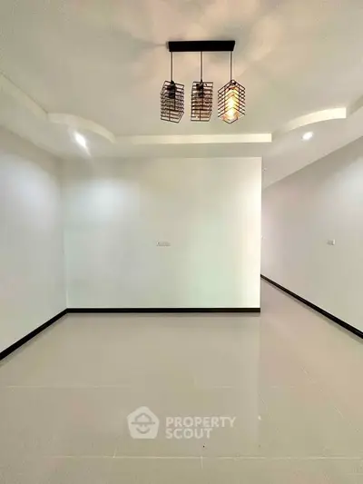 Spacious modern living room with elegant lighting and glossy tiled floor