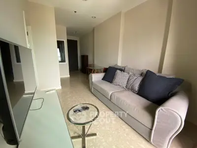 Modern living room with sleek sofa and TV, perfect for relaxation and entertainment.