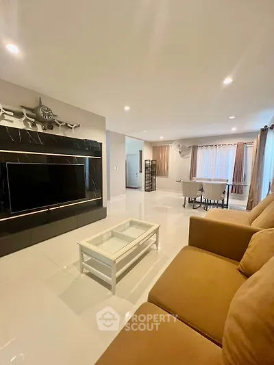 Spacious living room with modern decor and ample natural light
