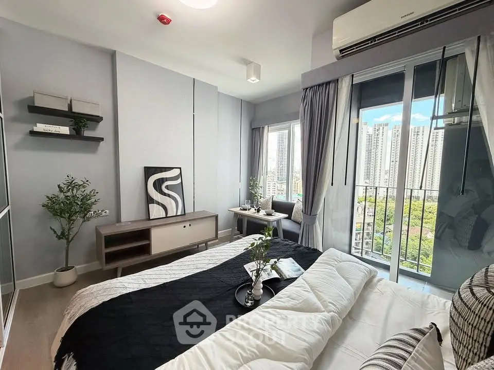 Modern bedroom with city view, featuring stylish decor and large windows for natural light.