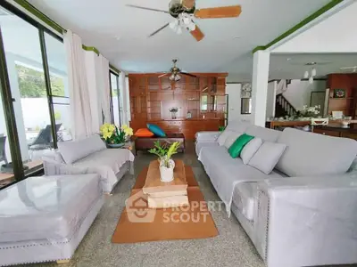 Spacious living room with modern decor and abundant natural light