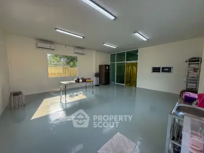 Spacious multipurpose room with modern lighting and large window