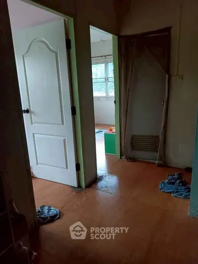Cozy interior with wooden flooring and natural light, perfect for a comfortable living space.