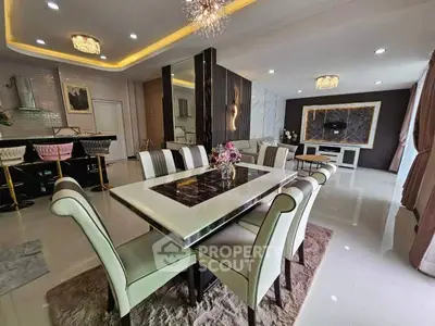 Luxurious dining room with elegant decor and modern lighting in a spacious open-plan layout.