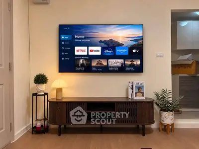 Modern living room with sleek TV setup and stylish decor, perfect for entertainment and relaxation.