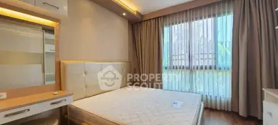 Spacious bedroom with elegant decor and large window for natural light