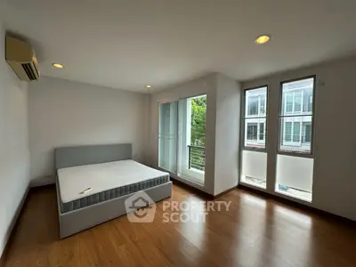 Spacious bedroom with large windows and modern design in a stylish apartment