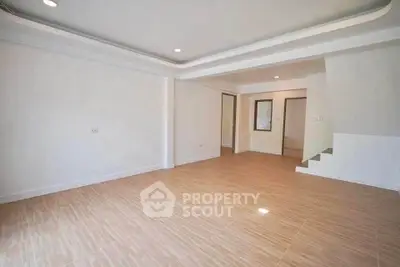 Spacious empty living room with modern design and wooden flooring, ready for customization.