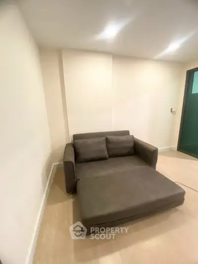 Cozy living room with modern sofa and soft lighting, perfect for relaxation.