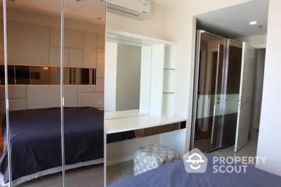 Modern bedroom with mirrored closet and stylish decor