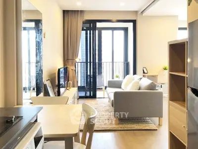 Modern living room with balcony access and stylish furniture in a bright apartment.