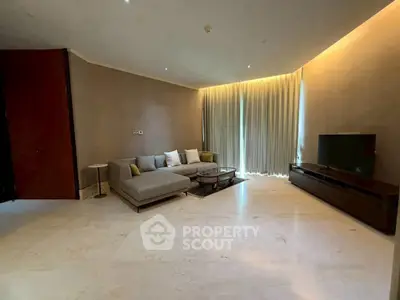 Spacious modern living room with elegant sofa and large TV unit