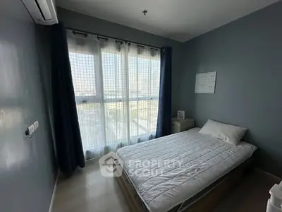 Cozy bedroom with large window and modern decor