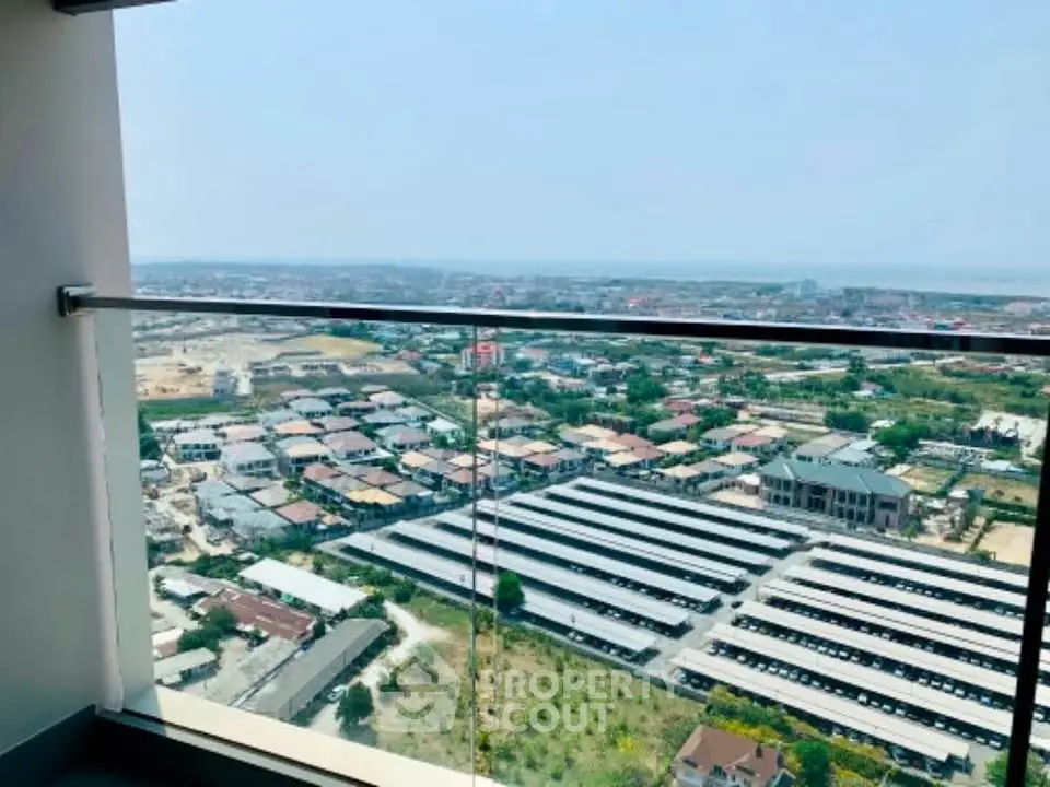 Stunning high-rise balcony view overlooking cityscape and distant horizon.