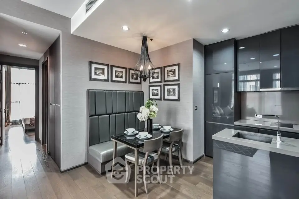 Modern dining area with elegant decor and sleek kitchen design in a stylish apartment.