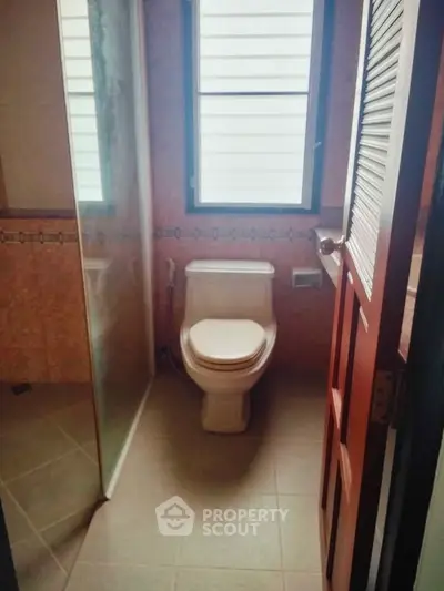 Cozy bathroom with modern fixtures and natural light from window