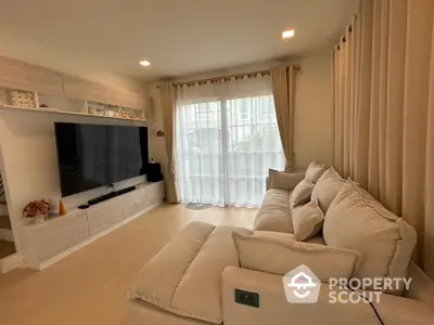 Spacious living room with large sofa and modern entertainment center