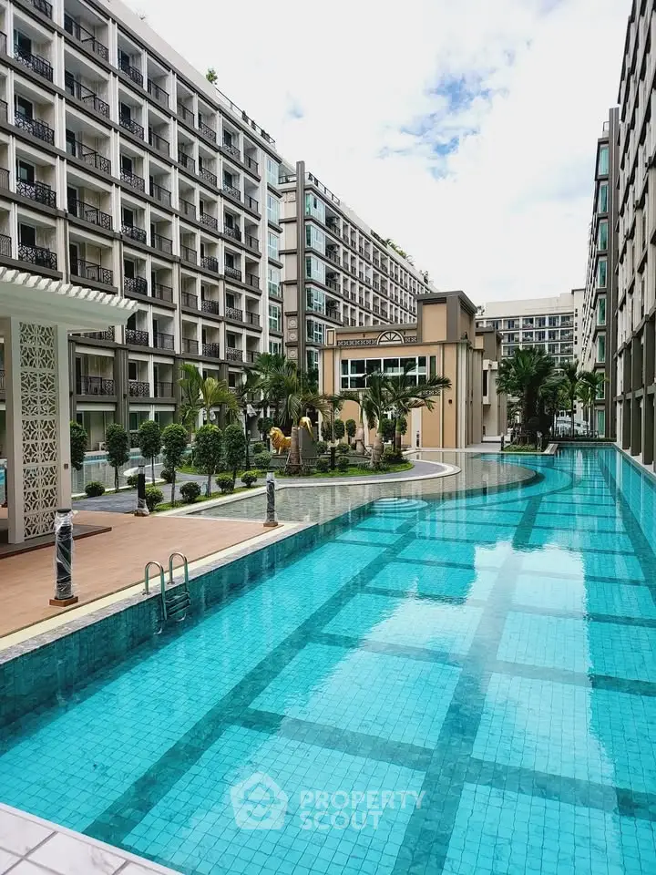 Luxurious apartment complex with stunning outdoor pool and modern architecture.