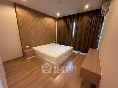 Spacious bedroom with modern decor and wooden flooring