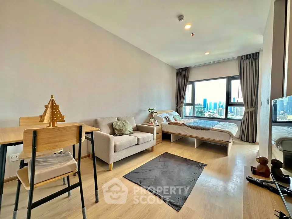 Modern studio apartment with city view, featuring cozy living area and stylish decor.