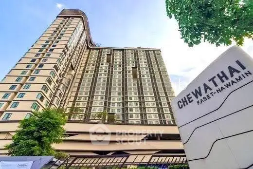 Modern high-rise building with lush greenery at Chewathai Kaset-Nawamin.