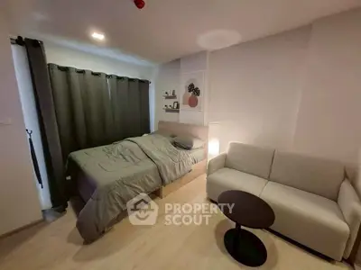 Cozy bedroom with modern decor and comfortable seating area.