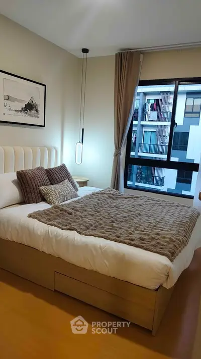 Cozy bedroom with modern decor and large window view