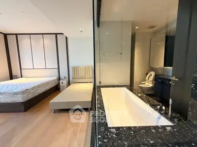 Luxurious bedroom with ensuite bathroom featuring a sleek bathtub and modern design.