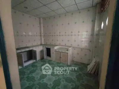Spacious kitchen with tiled walls and floors, ready for customization.