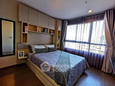 Modern bedroom with large window and stylish decor in urban apartment