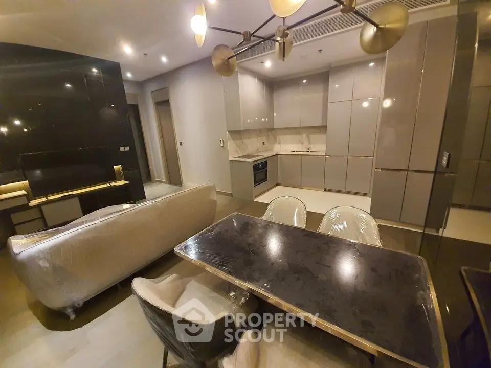 Modern open-layout kitchen and living room with sleek design and contemporary furniture.