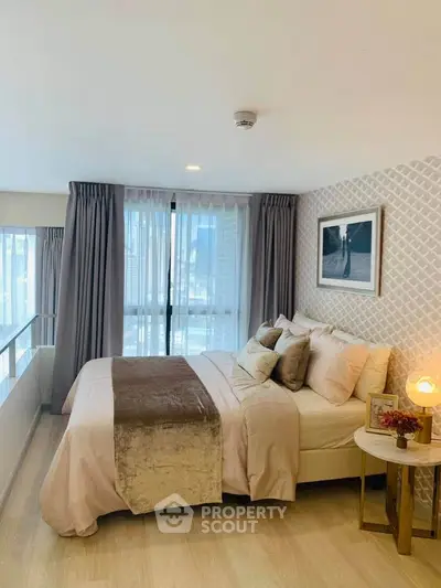 Luxurious bedroom with elegant decor and large windows offering natural light.