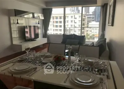 Stylish living room with dining area and city view, featuring modern decor and ample natural light.