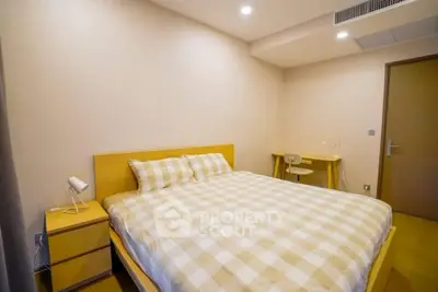 Cozy bedroom with modern furniture and soft lighting, perfect for relaxation.