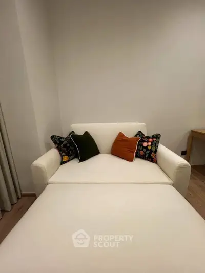 Cozy modern living room with stylish white sofa and colorful cushions