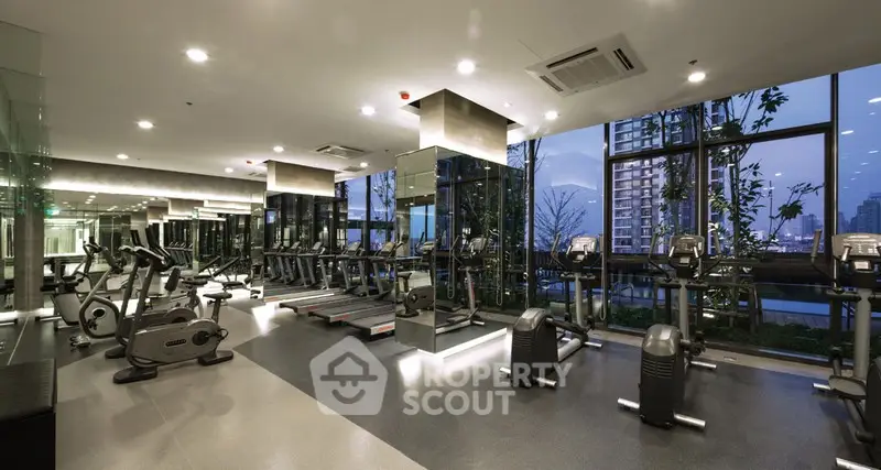 Modern gym with city view and state-of-the-art equipment in luxury building.