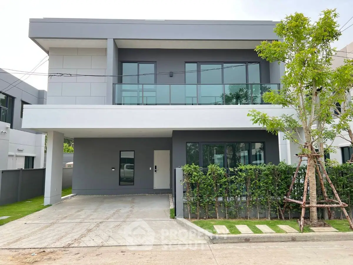 Modern two-story house with sleek design and spacious driveway