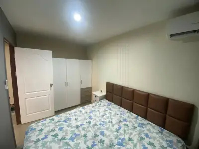 Cozy bedroom with modern furnishings and air conditioning unit, perfect for comfortable living.