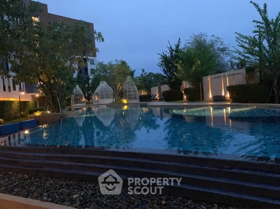 Luxurious residential pool area with ambient lighting and modern design.