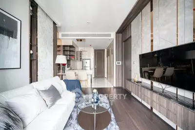 Luxurious modern living room with elegant decor and open kitchen layout, featuring sleek furniture and stylish design.