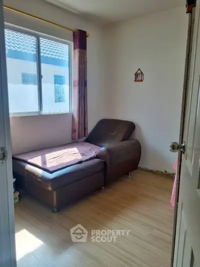 Cozy small bedroom with natural light and simple decor