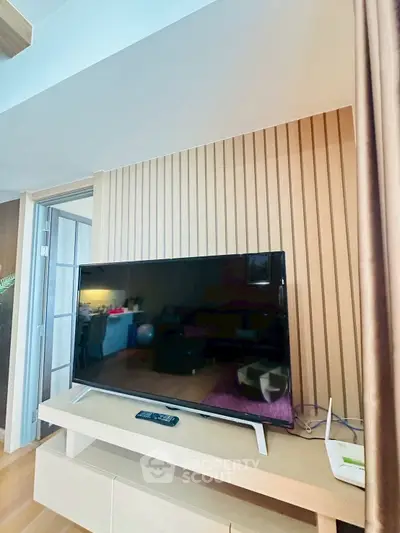 Modern living room with sleek TV setup and stylish wooden paneling
