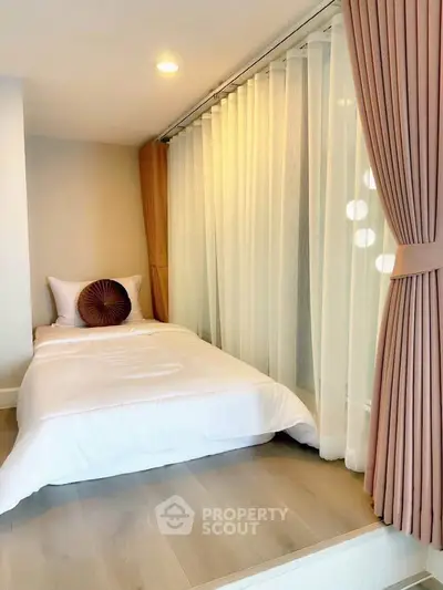 Cozy bedroom with elegant curtains and soft lighting, perfect for relaxation.