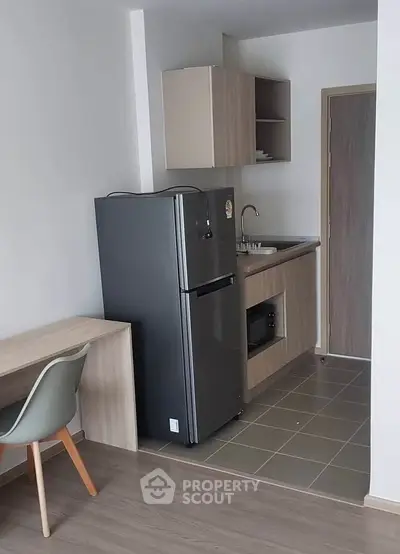 Modern compact kitchen with sleek appliances and minimalist design