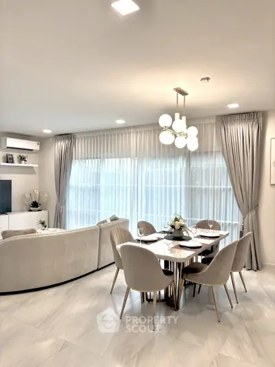 Elegant living room with modern dining area and stylish lighting