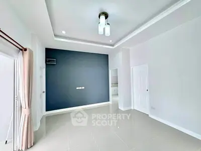 Spacious modern living room with elegant lighting and neutral tones